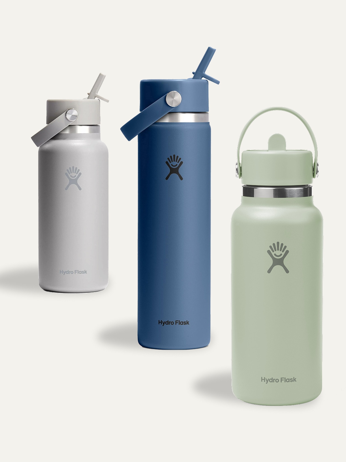 Three Hydro Flask bottles on a light colored background.