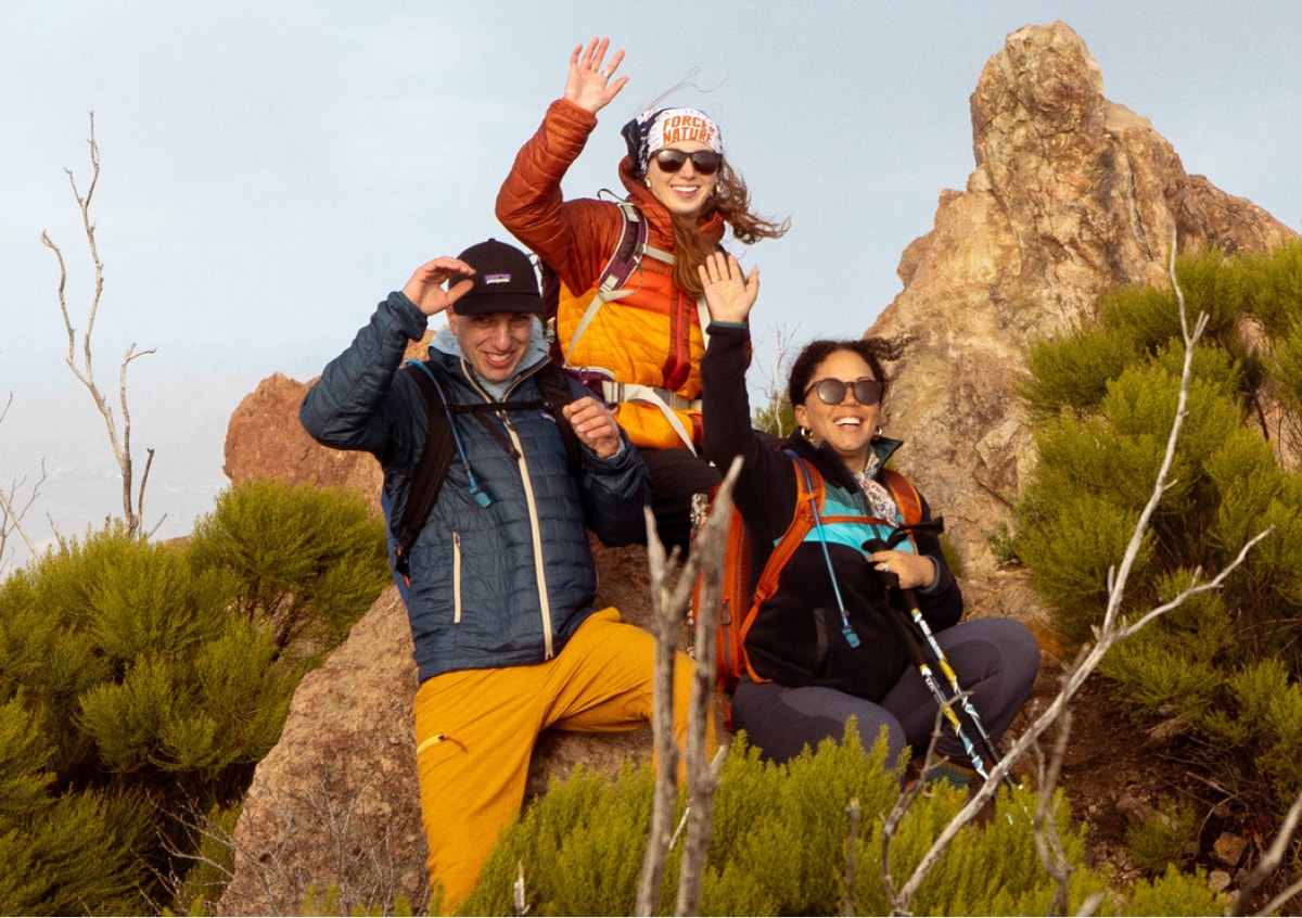A group of people waving for the camera.