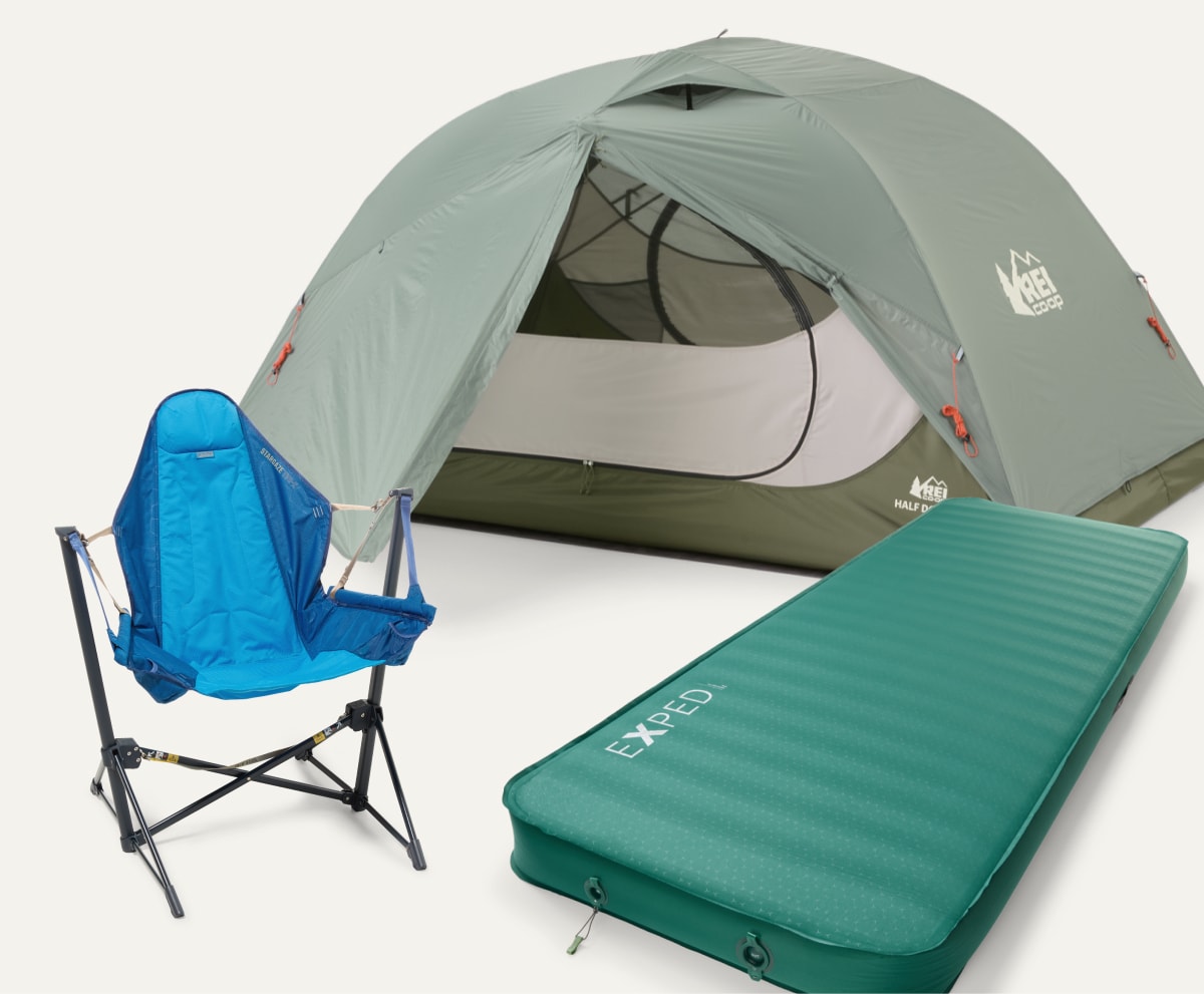 A camp chair, a tent, and a sleeping pad on a light colored background.