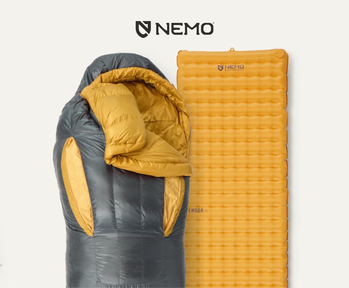 A sleeping bag and pad from NEMO on a light colored background.