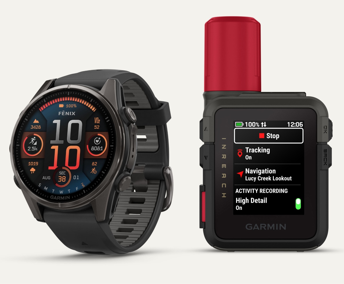 A Garmin satellite device and smartwatch on a light colored background.