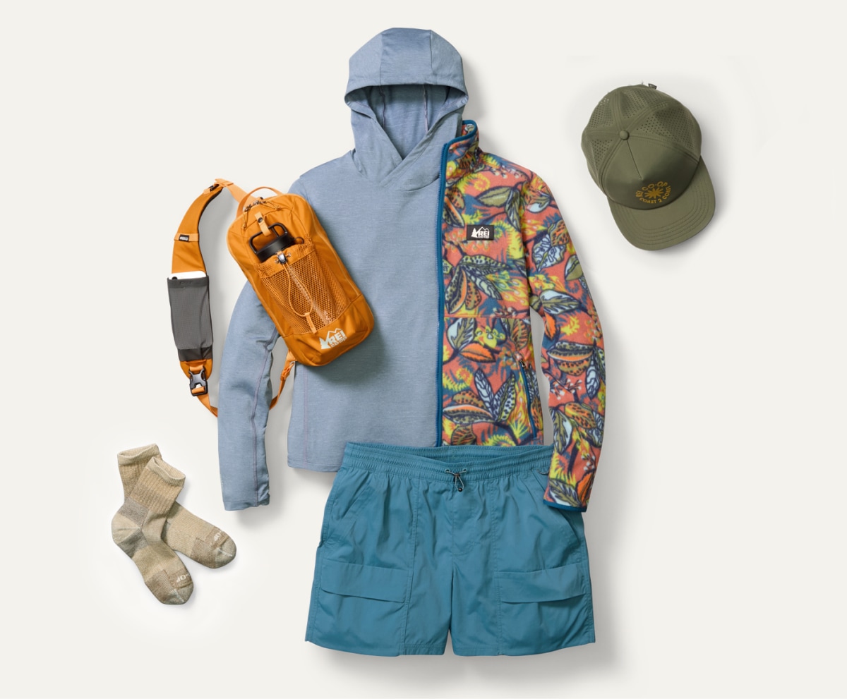 A collage of R E I Co-op brand clothing and gear on a light colored background.