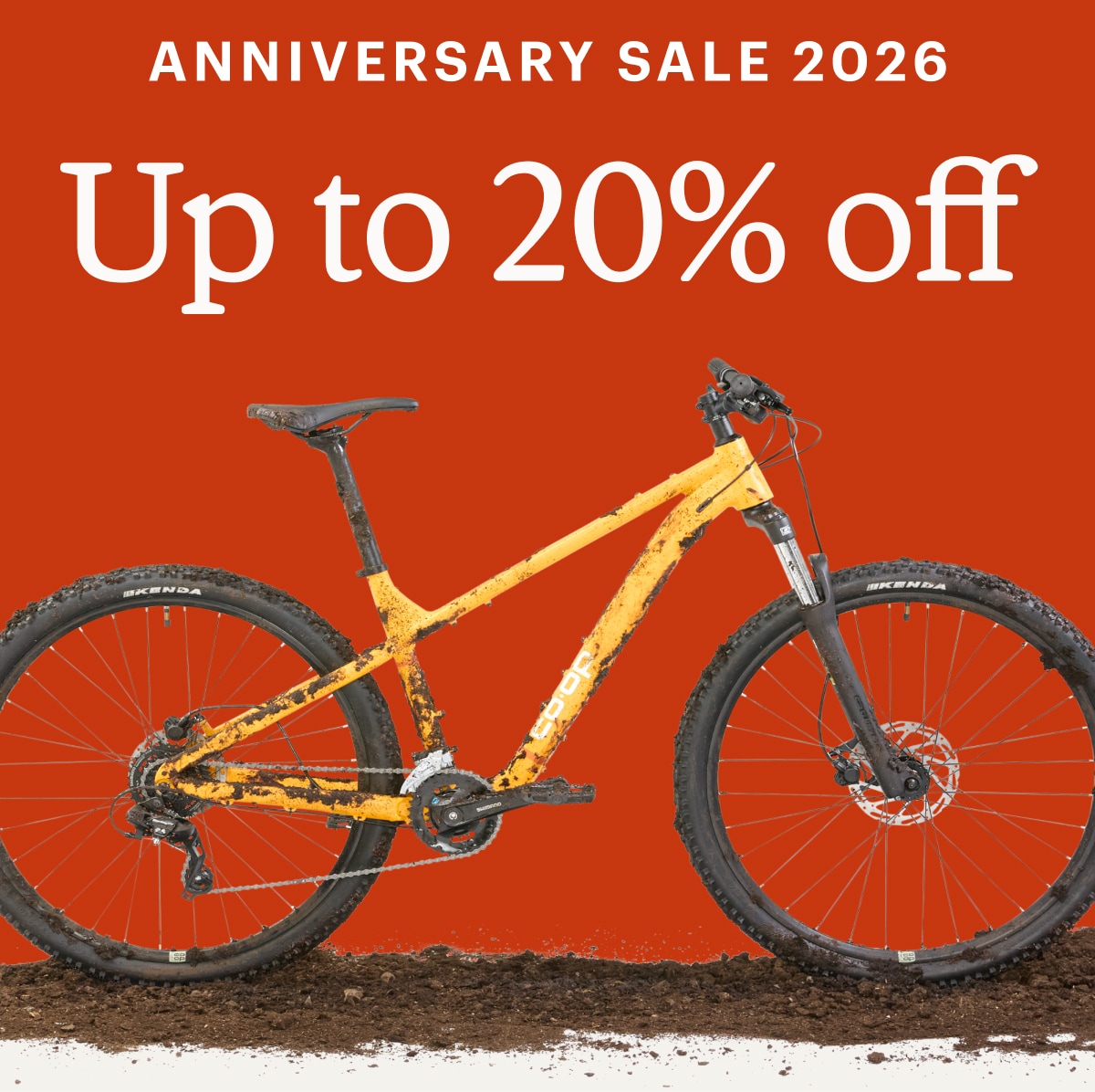Text reads: ‘Anniversary Sale 2026. 20% off’ over a muddy Co-op Cycles bike.