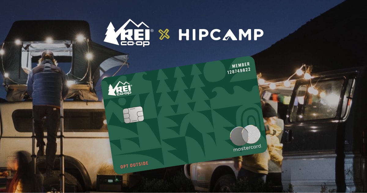 The R E I Co-op Mastercard over an image of a person climbing into a rooftop tent at a campsite.