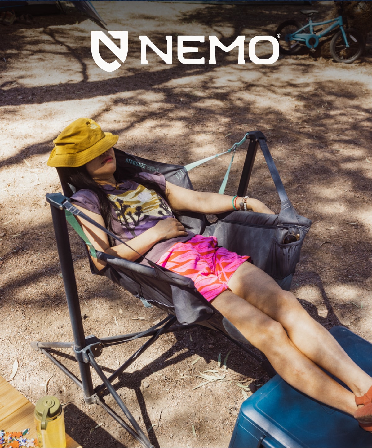 A person relaxes in the NEMO Stargave Evo-X reclining camp chair.