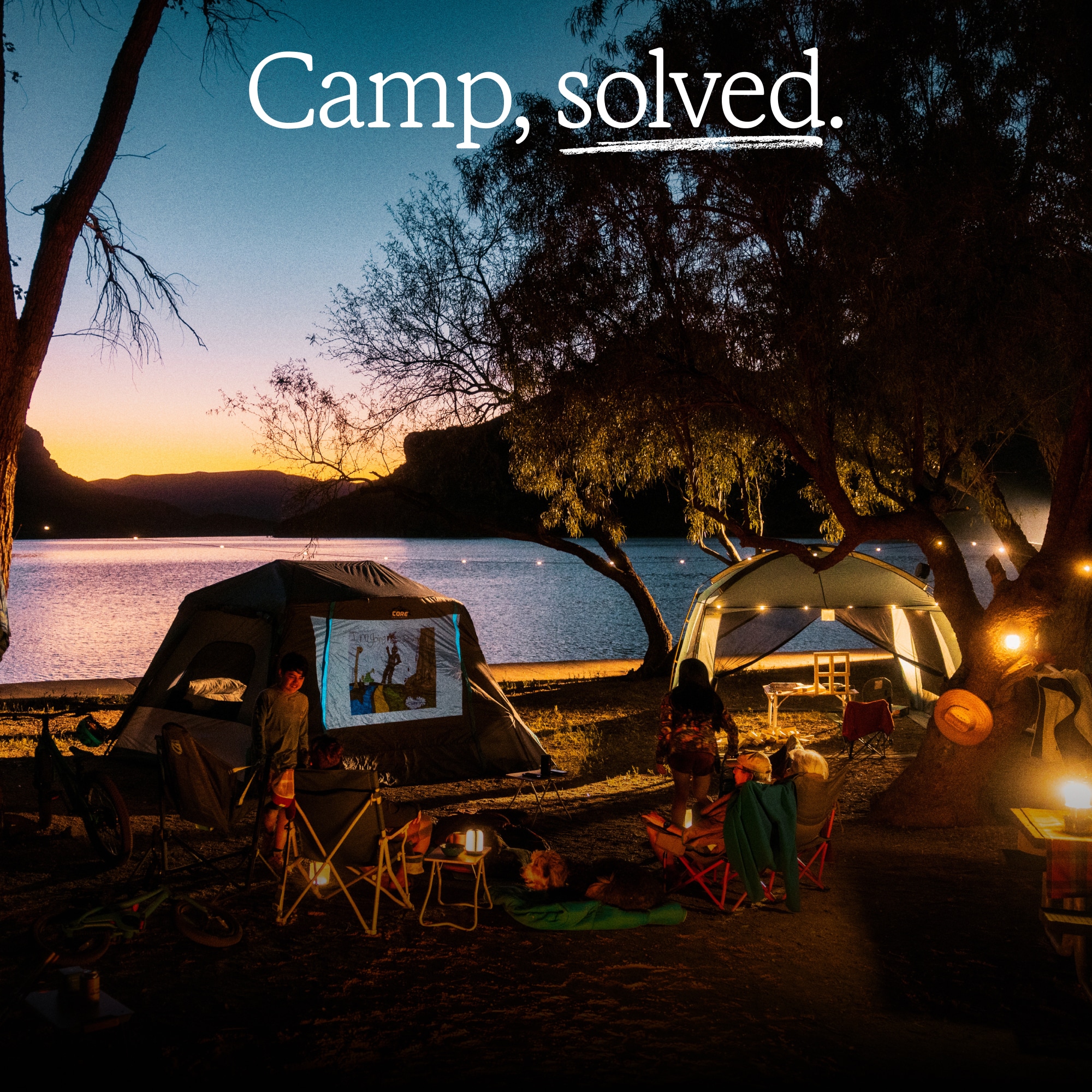 R E I Co-op, NEMO, & YETI. Text reads: ‘Camp, solved.’ over an image of a campsite near a lake with the sun setting in the background.