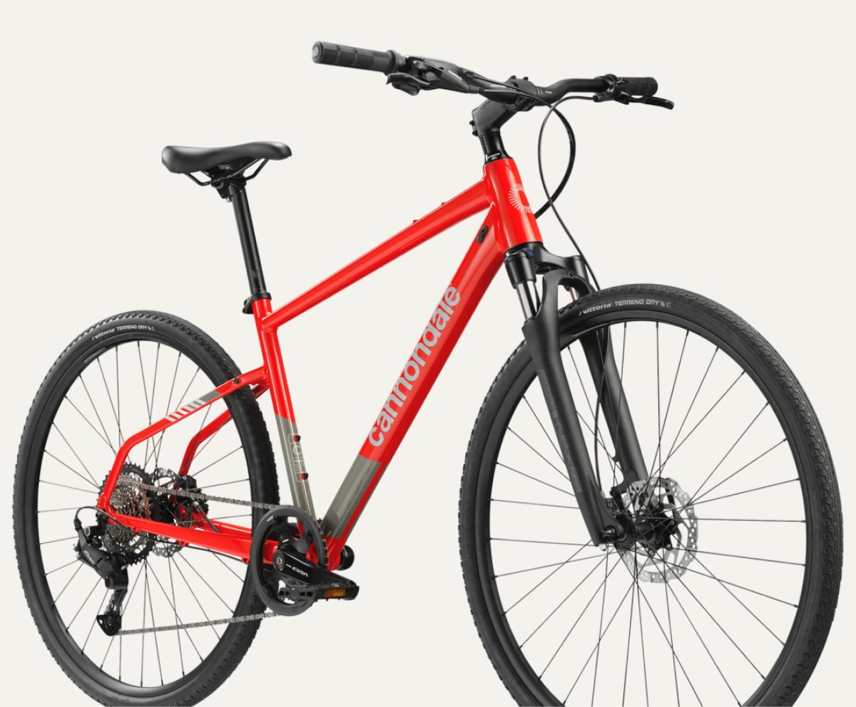 A red Cannondale bike on a light colored background.