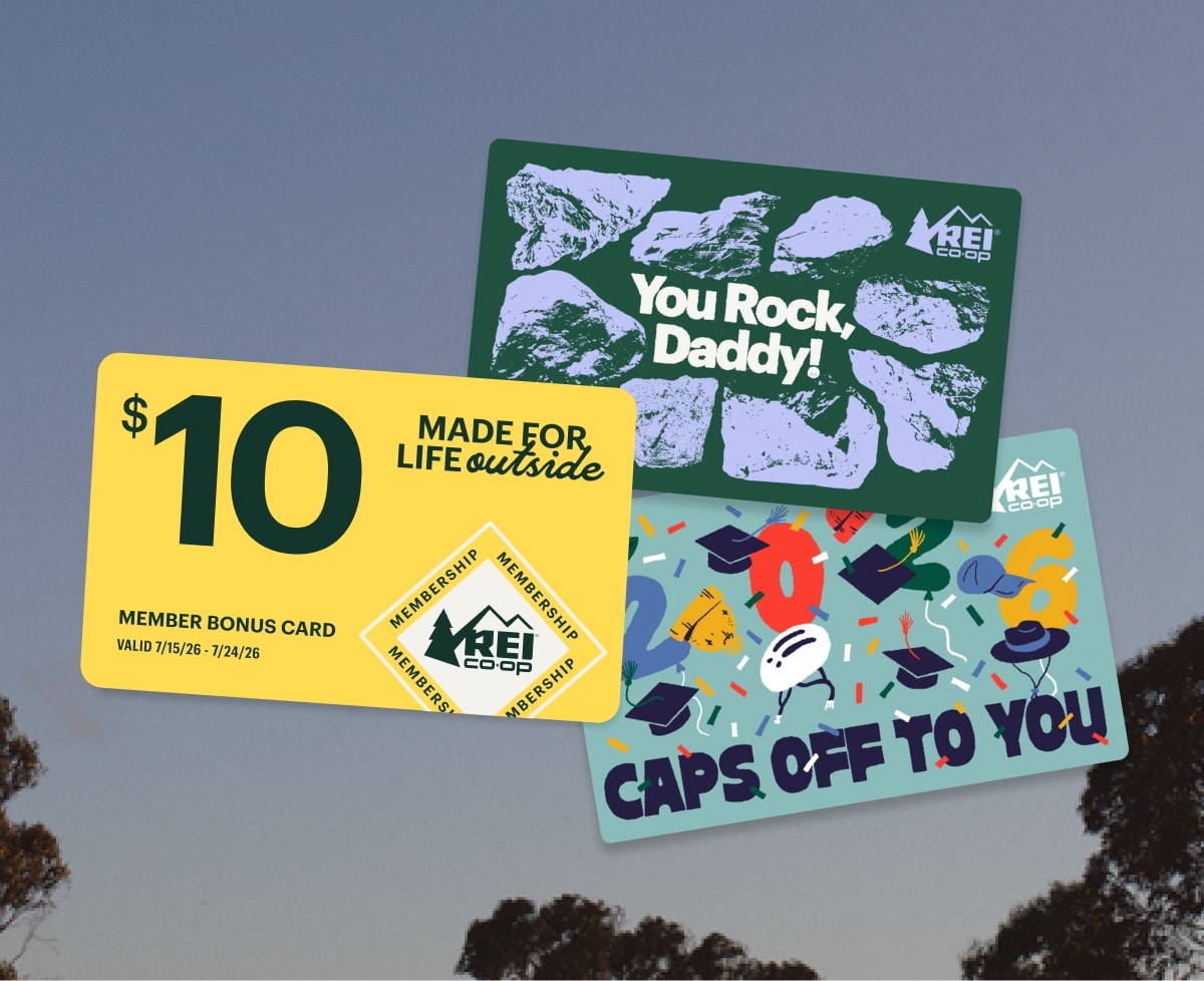 Two gift cards and a yellow Member Bonus Card over an image of blue skies and trees.