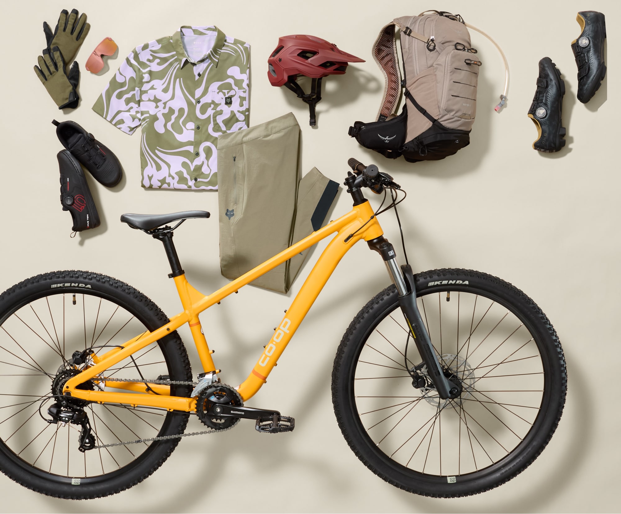 A Co-op Cycles bike with a collage of clothing and gear.
