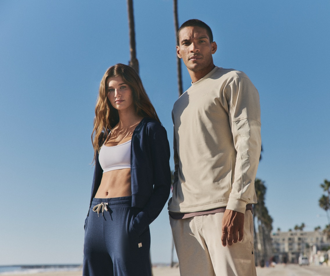 Two people pose for the camera together in their Vuori clothing.