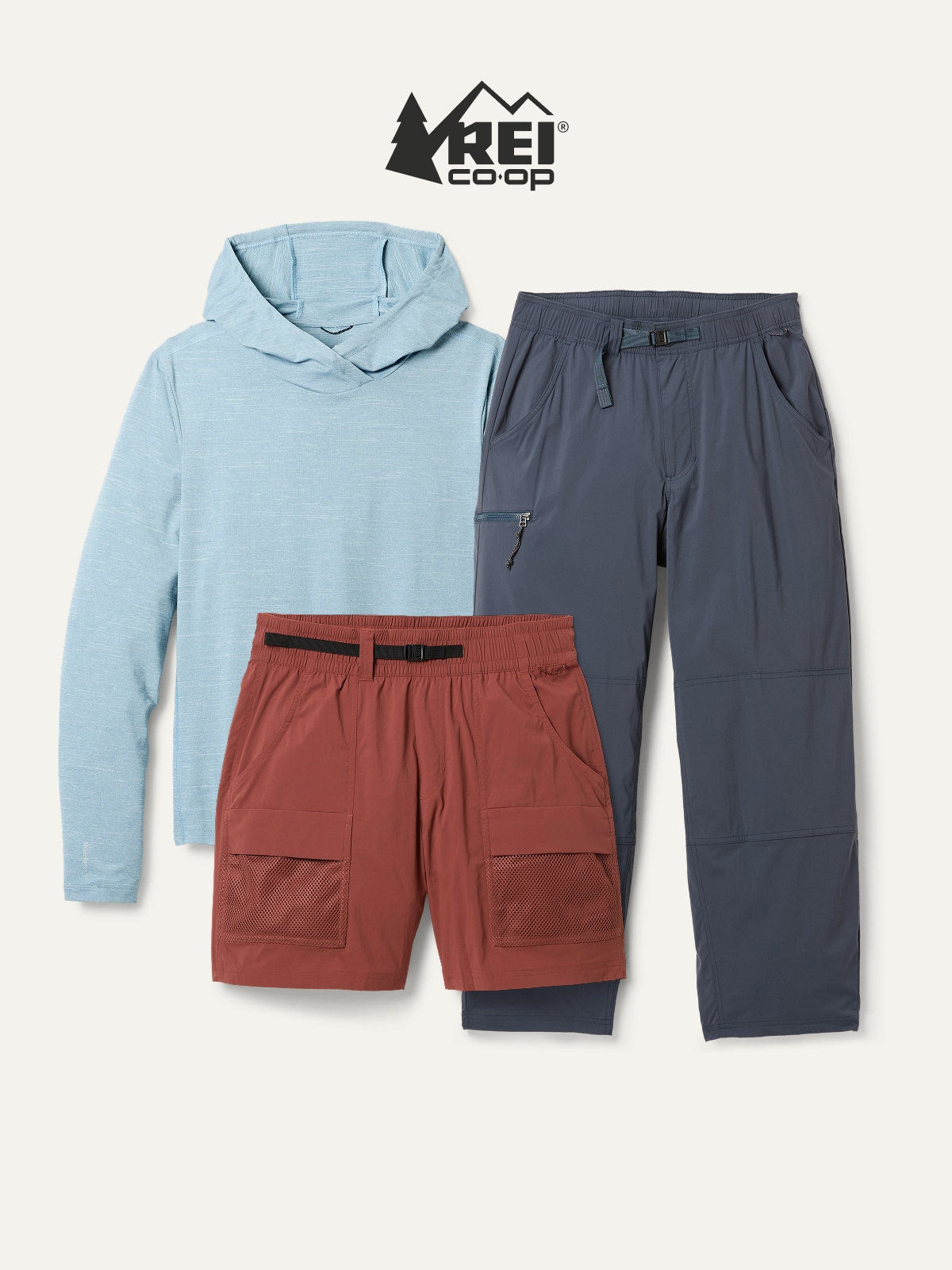 An R E I Co-op brand long-sleeve top, pants, and shorts on a light colored background.