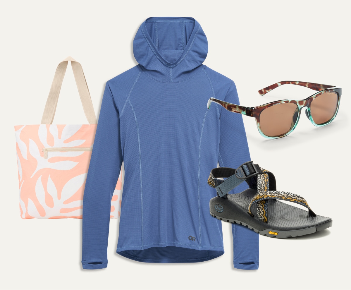 An Outdoor Research Echo Hoodie, a tote bag, a Chaco sandal, and Tifosi sunglasses on a light colored background.