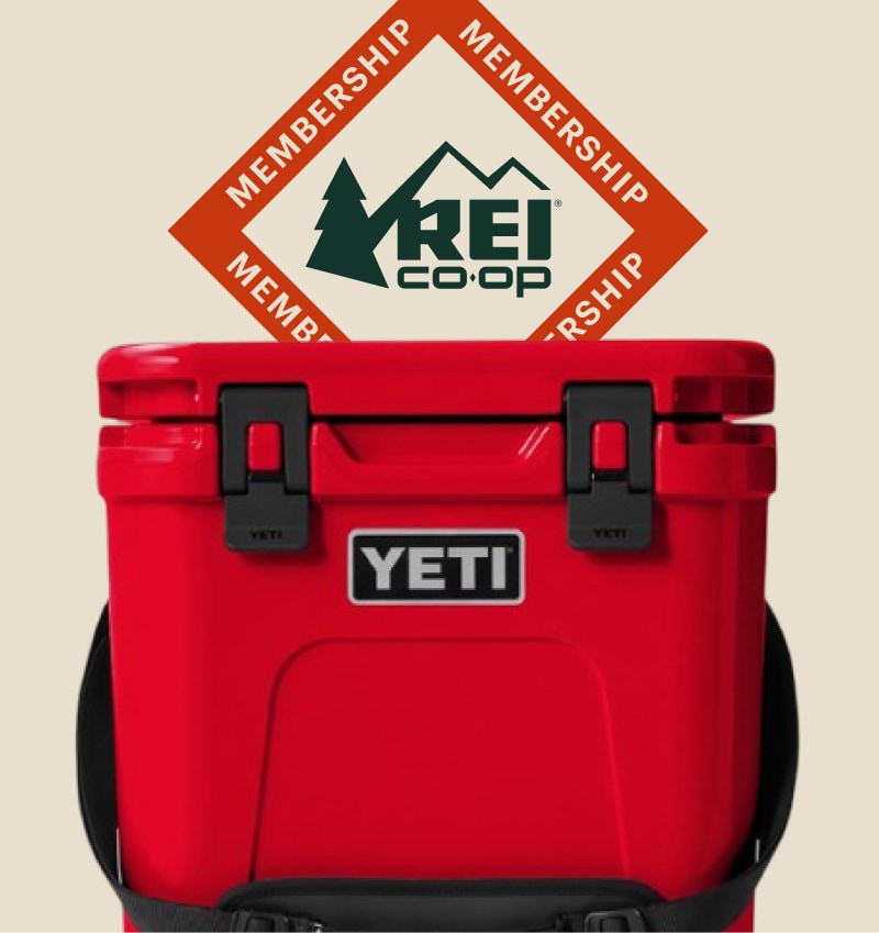 Text reads: ‘R E I Co-op membership’ over a red YETI cooler on a light colored background.