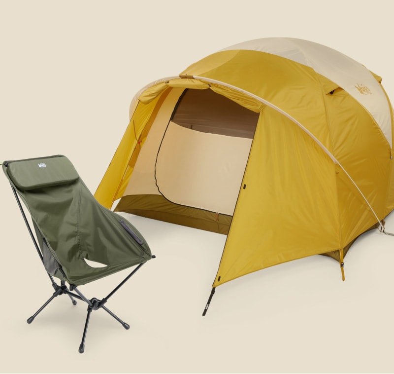 A sleeping bag, camp chair, and tent on a light colored background.