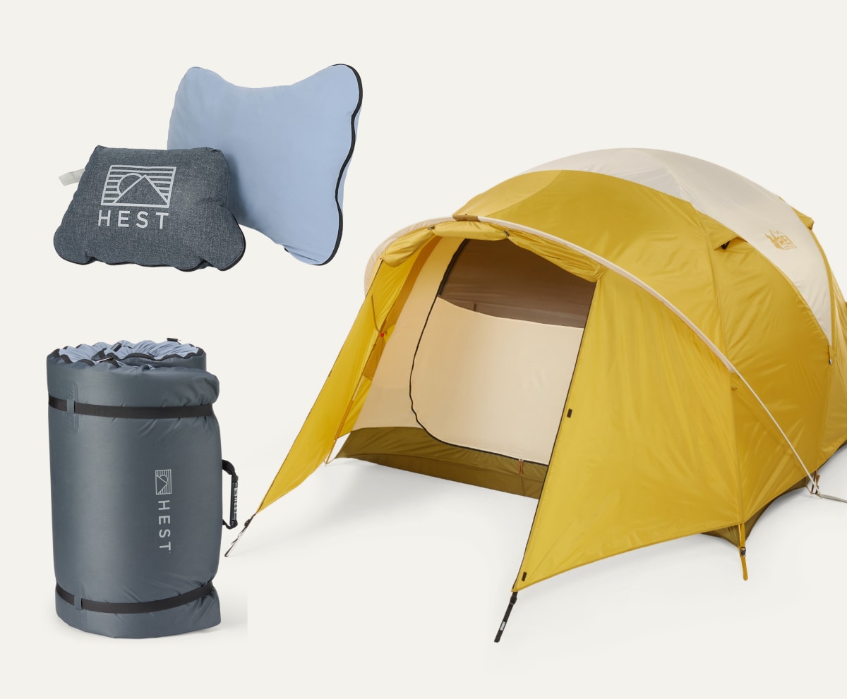 A HEST Camp Pillow and Sleeping Pad and an R E I Co-op brand tent on a light colored background.