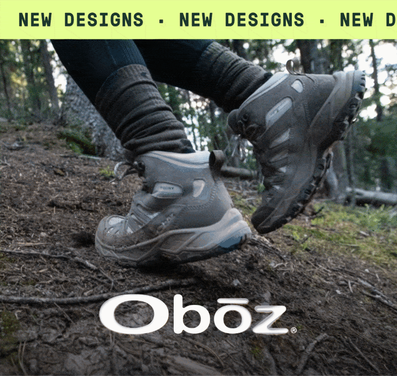 A person hikes through a forest trail in their Oboz hiking boots. Text reads: ‘New designs.’
