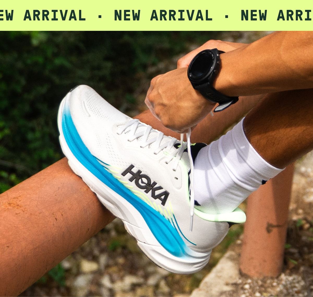 A person stops to tie the laces on their HOKA Clifton 11 shoe. Text reads: ‘New arrival.’
