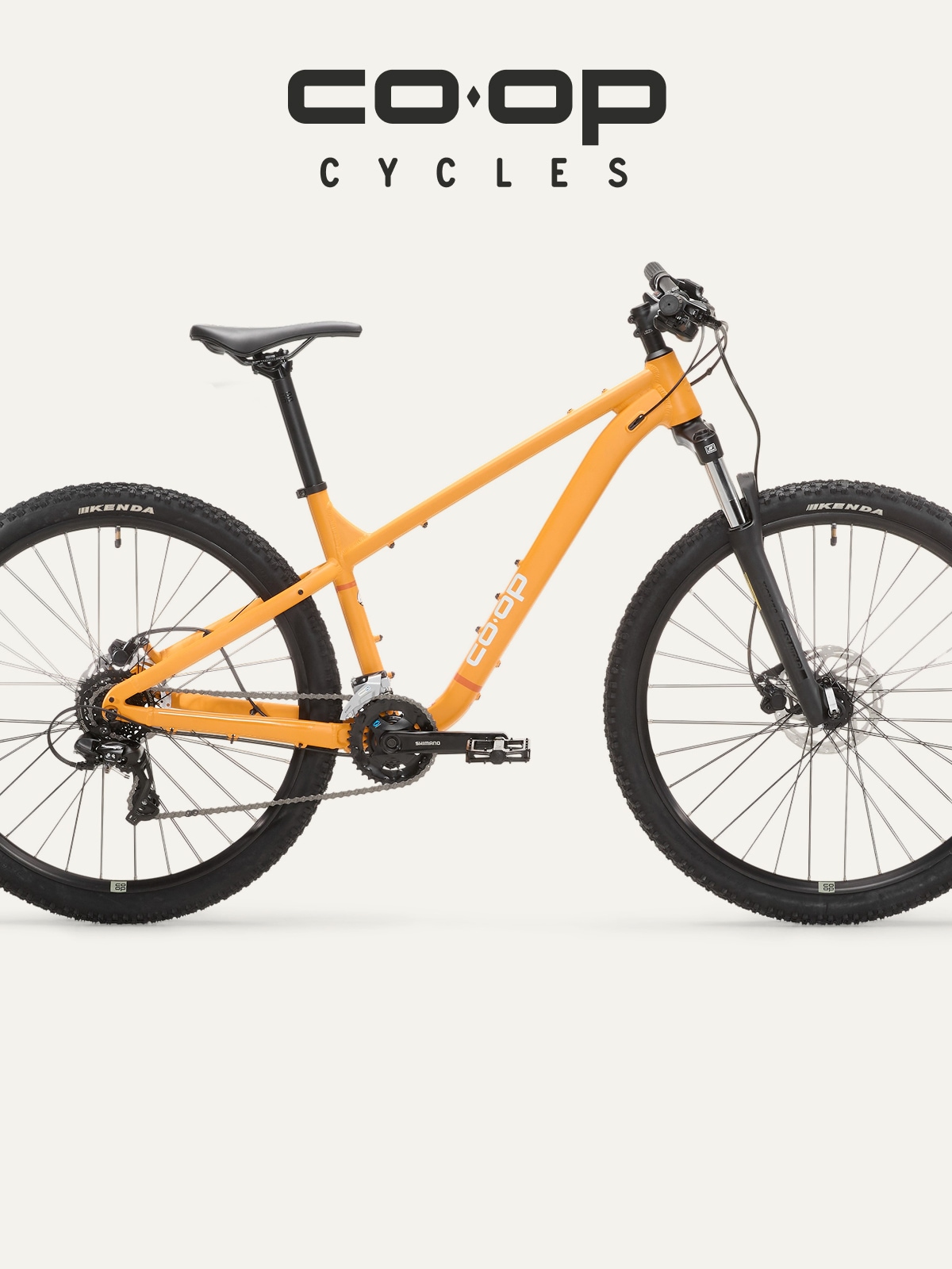 A yellow Co-op Cycles bike on a light colored background.