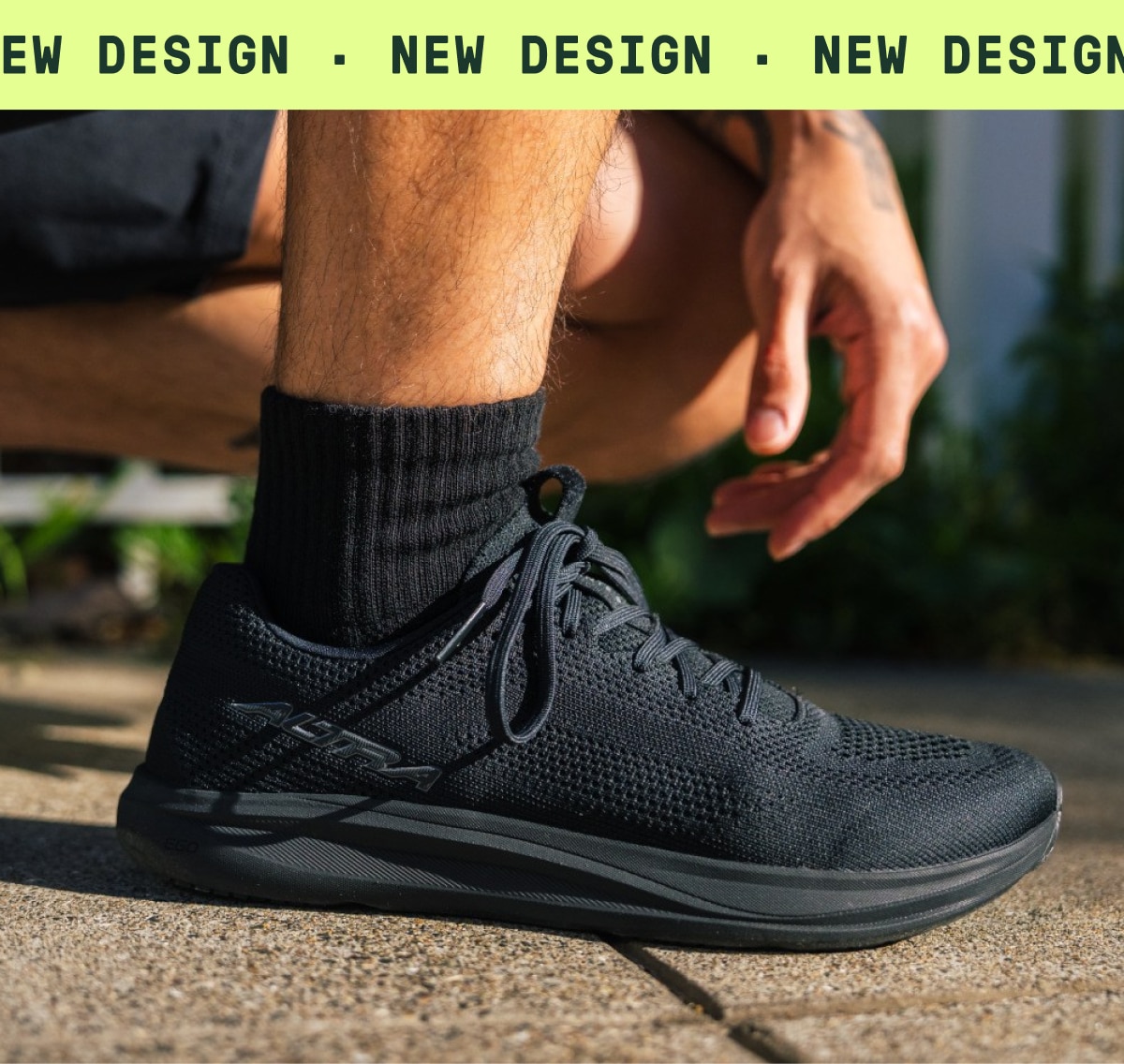 A person kneels down in their Altra Escalante 5 running shoes. Text reads: ‘New design.’