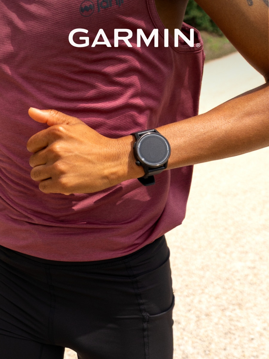 A person runs while wearing a Garmin smartwatch.