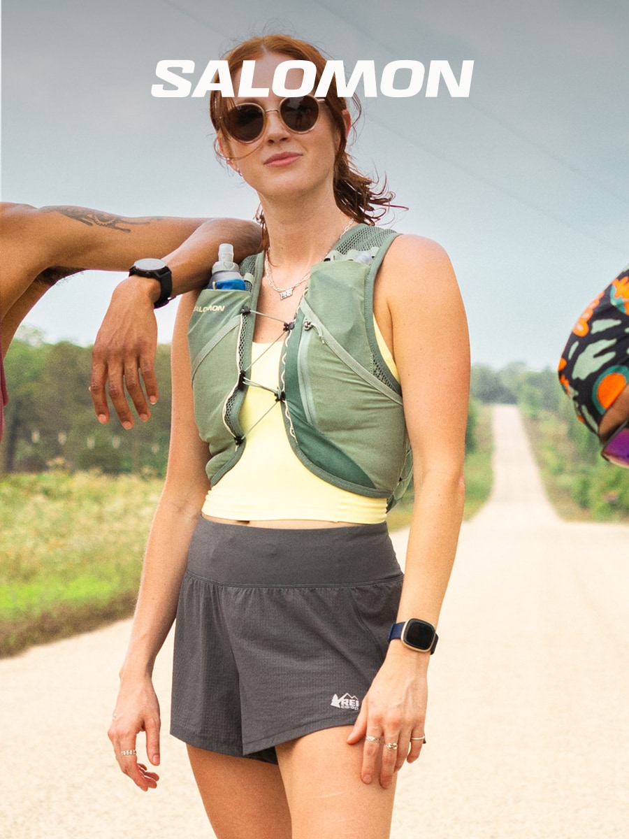 A person poses for the camera in a Salomon hydration vest.