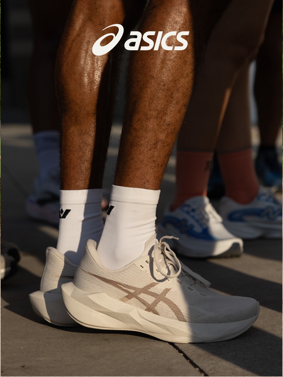A person standing up in their ASICS running shoes.