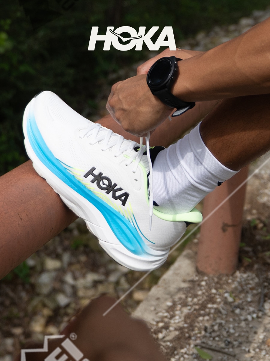 A person ties the laces on their HOKA Clifton 11 shoe.