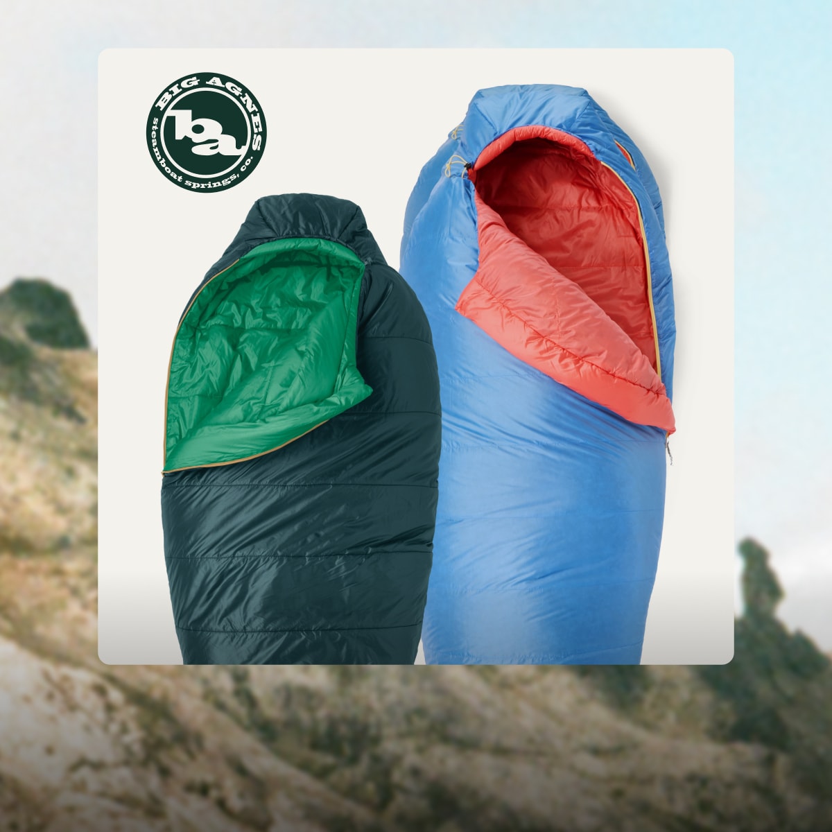 Two Big Agnes sleeping bags on a light colored background over an image of a grass covered mountain.