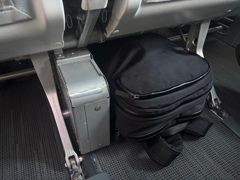 A black travel pack fit neatly in the seat.