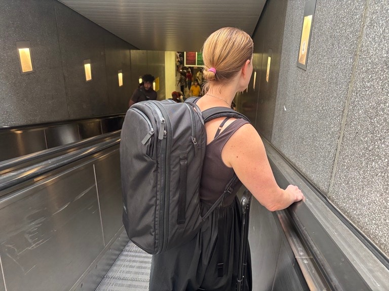A person wears the Bellroy Transit Travel Pro pack on her way to catch the Eurostar train.