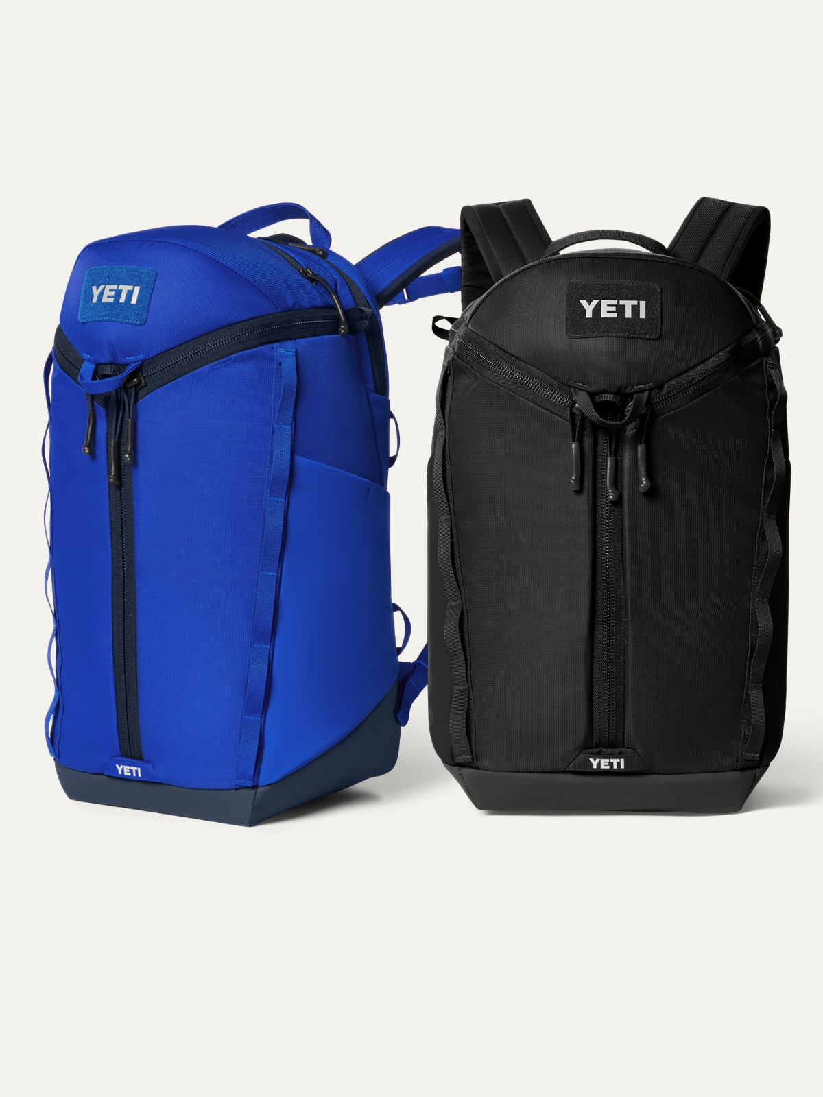 Two YETI backpacks on a light colored background.