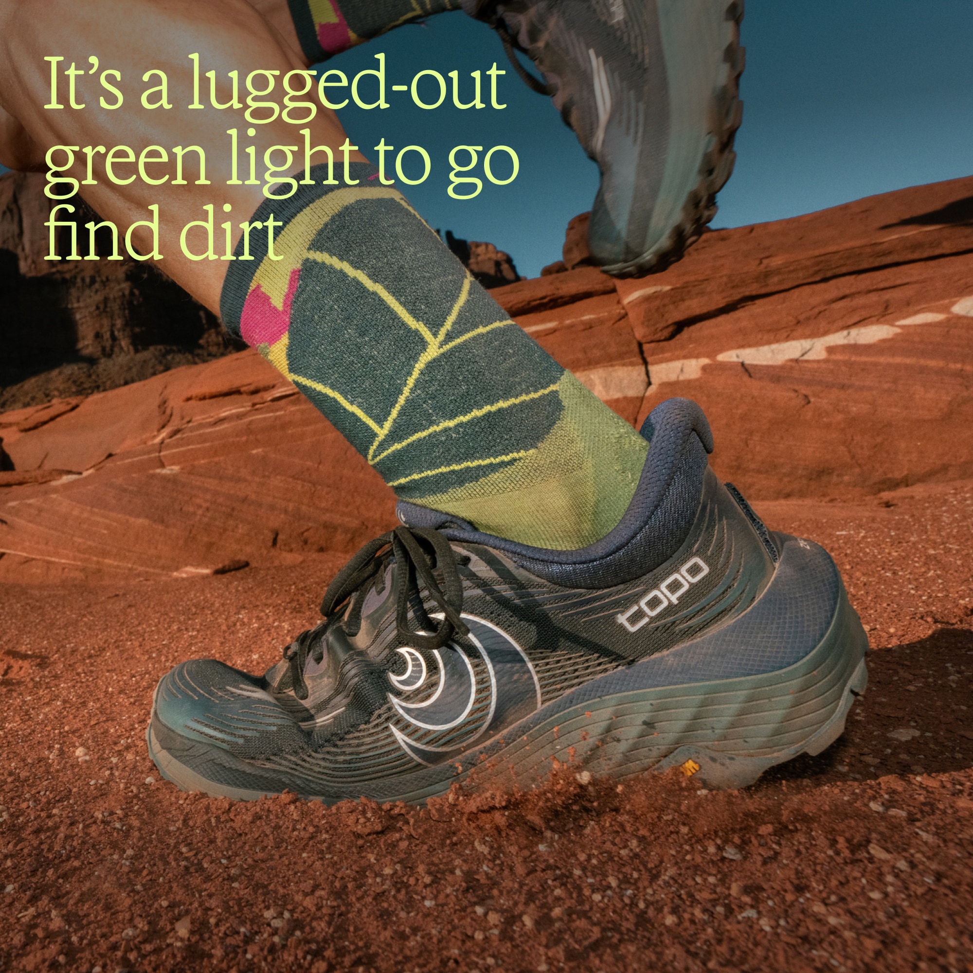 Text reads: ‘It’s a lugged-out green light to go find dirt’ over an image of a person running through dirt in their Topo Athletic shoes.