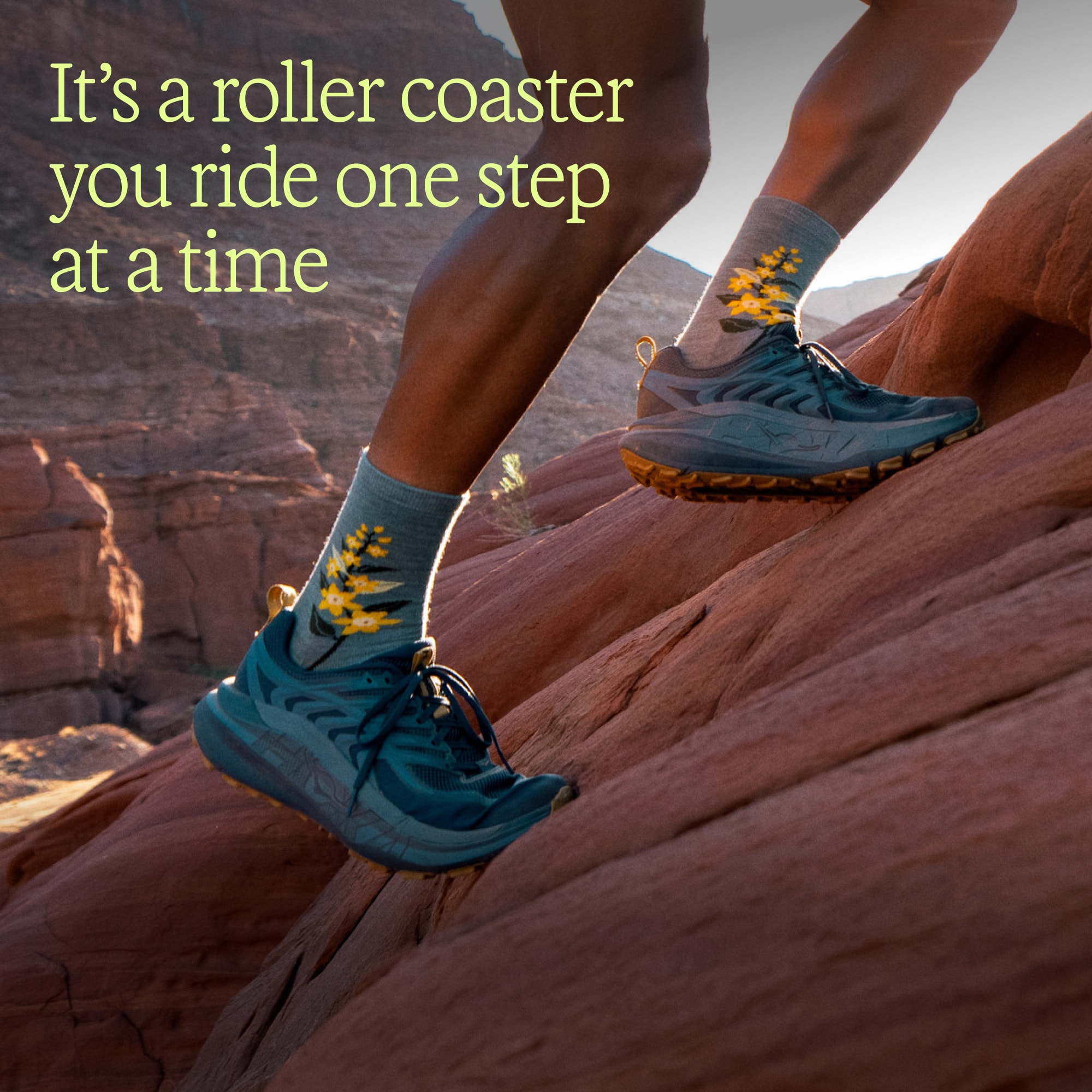 Text reads: ‘It’s a roller coaster you ride one step at a time’ over an image of a person running up a steep rock in their HOKA Stinson 8 shoes.
