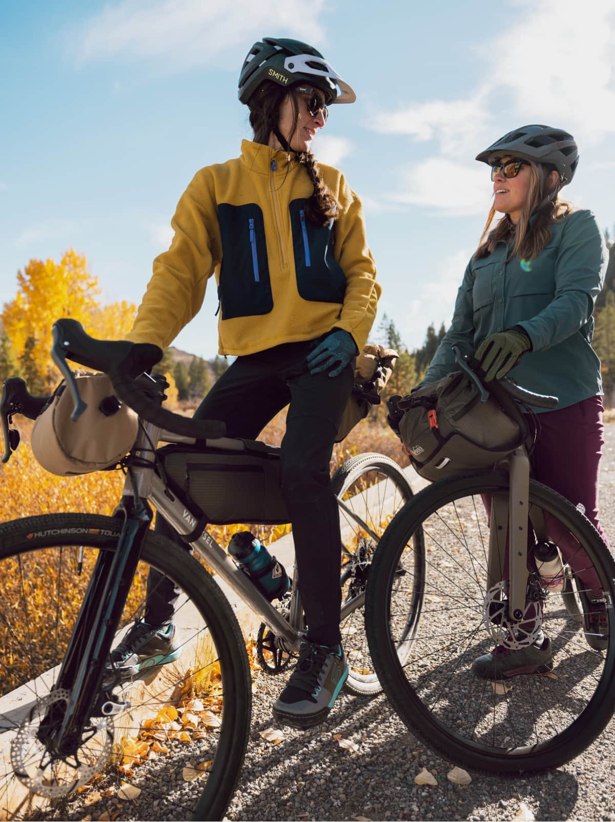 Two people stop their bike ride to take a break and have conversation.