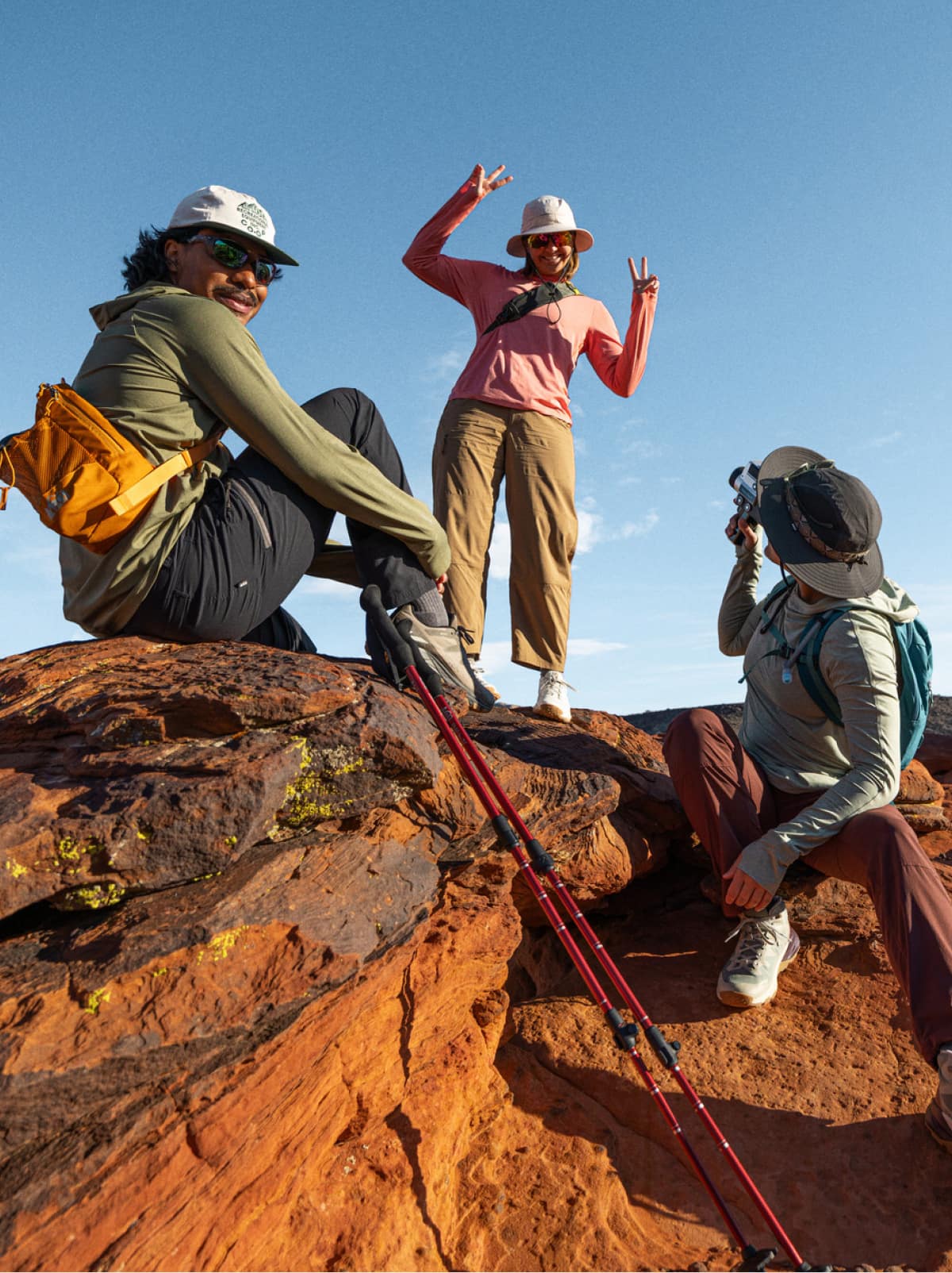 Three hikers smile and pose for the camera.