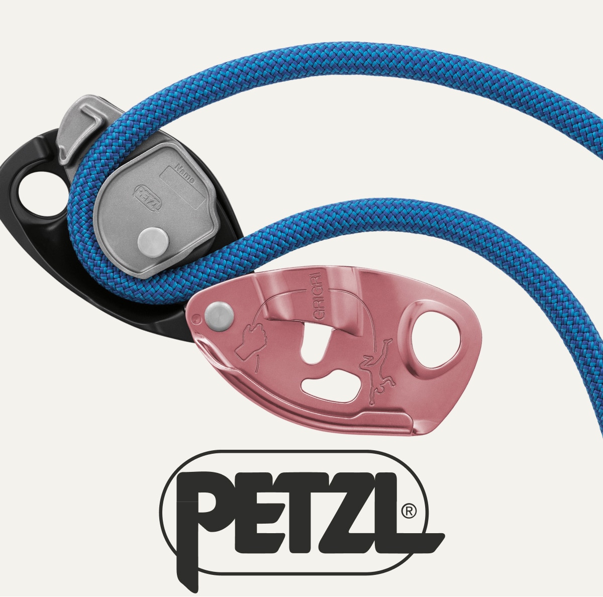 A pink Petzl GRIGRI belay device and blue climbing rope on a light colored background.