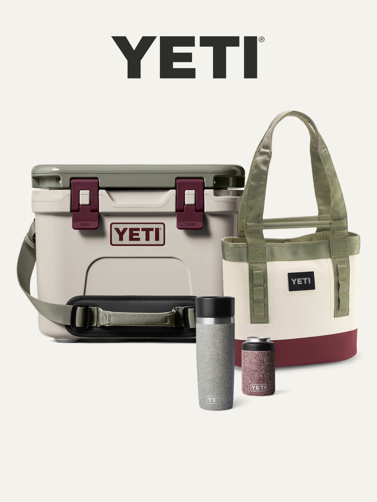 A YETI hard cooler, tote bag, & insulated drinkware on a light colored background.