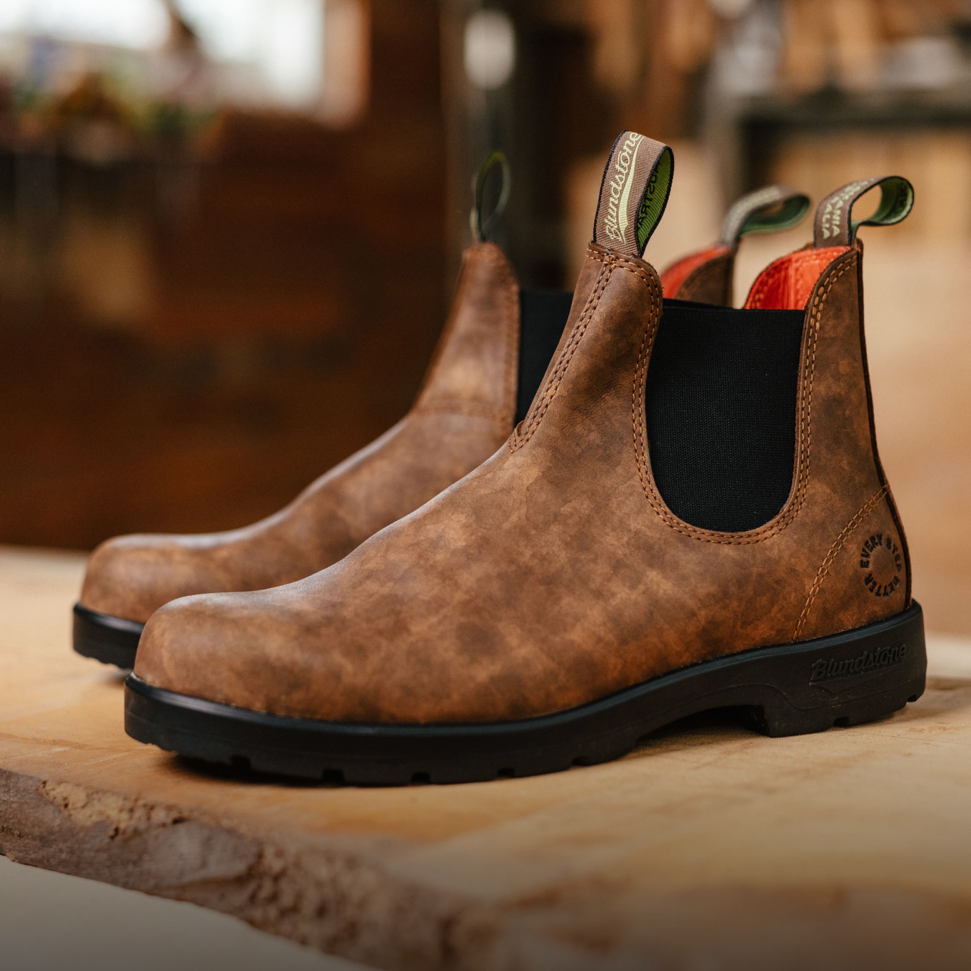 A pair of Blundstone Classic Retread boots sitting on top of a wooden surface.