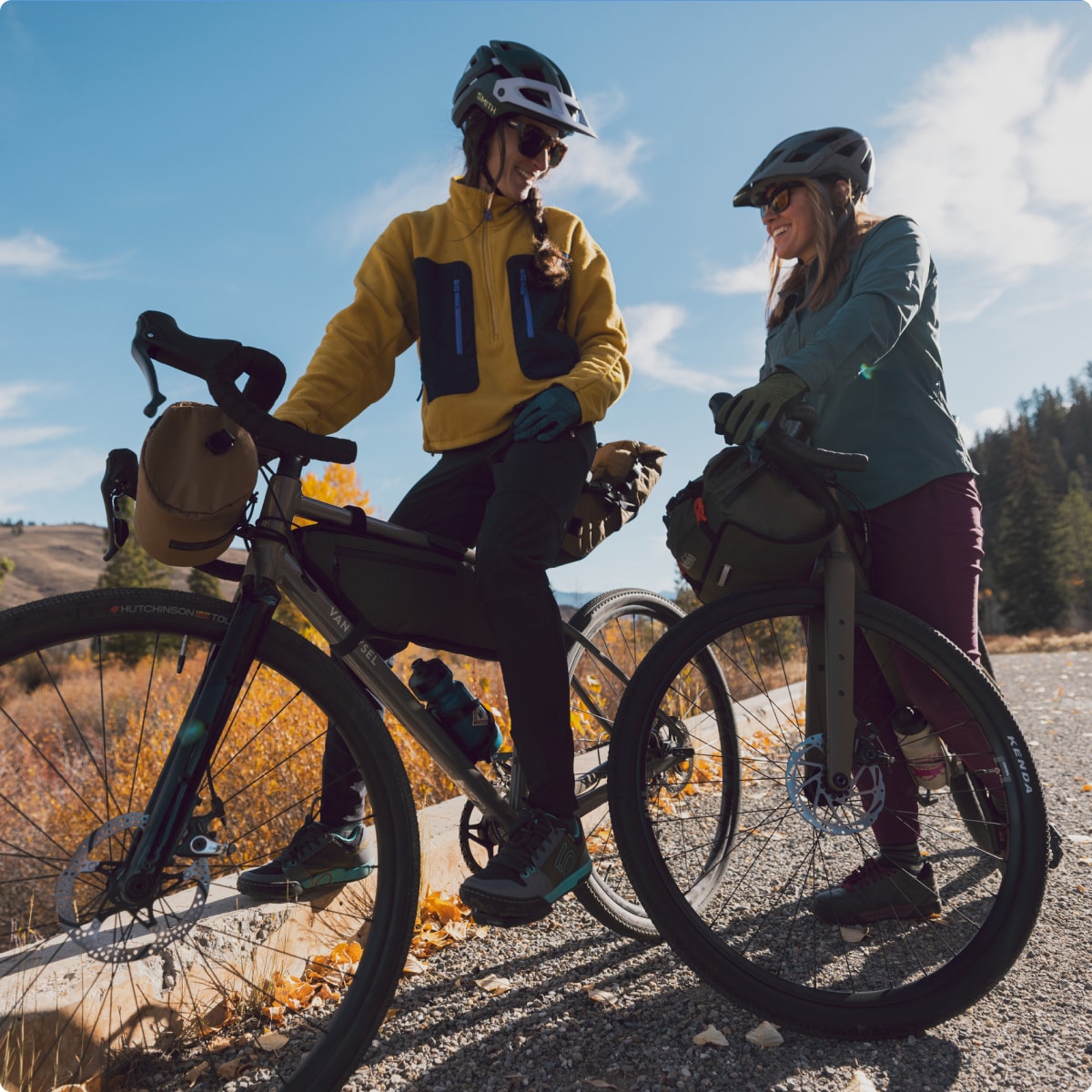 Two people stop to take a break while cycling.