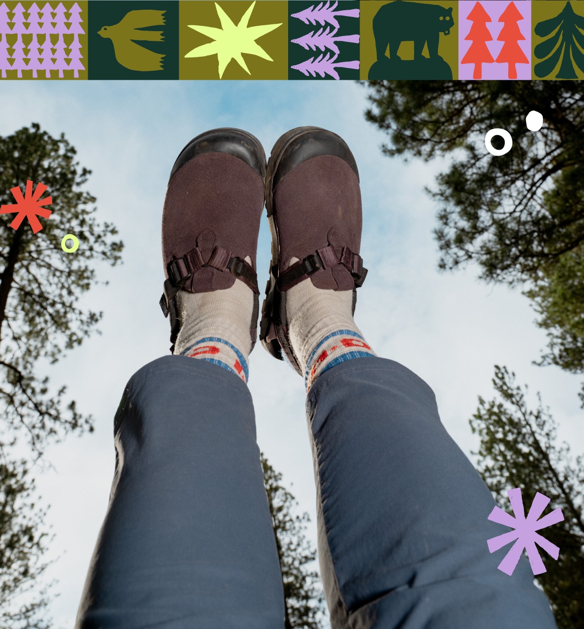 A person with their feet up in the air wearing Bedrock Mountain Clogs with cloudy skies and trees in the background.