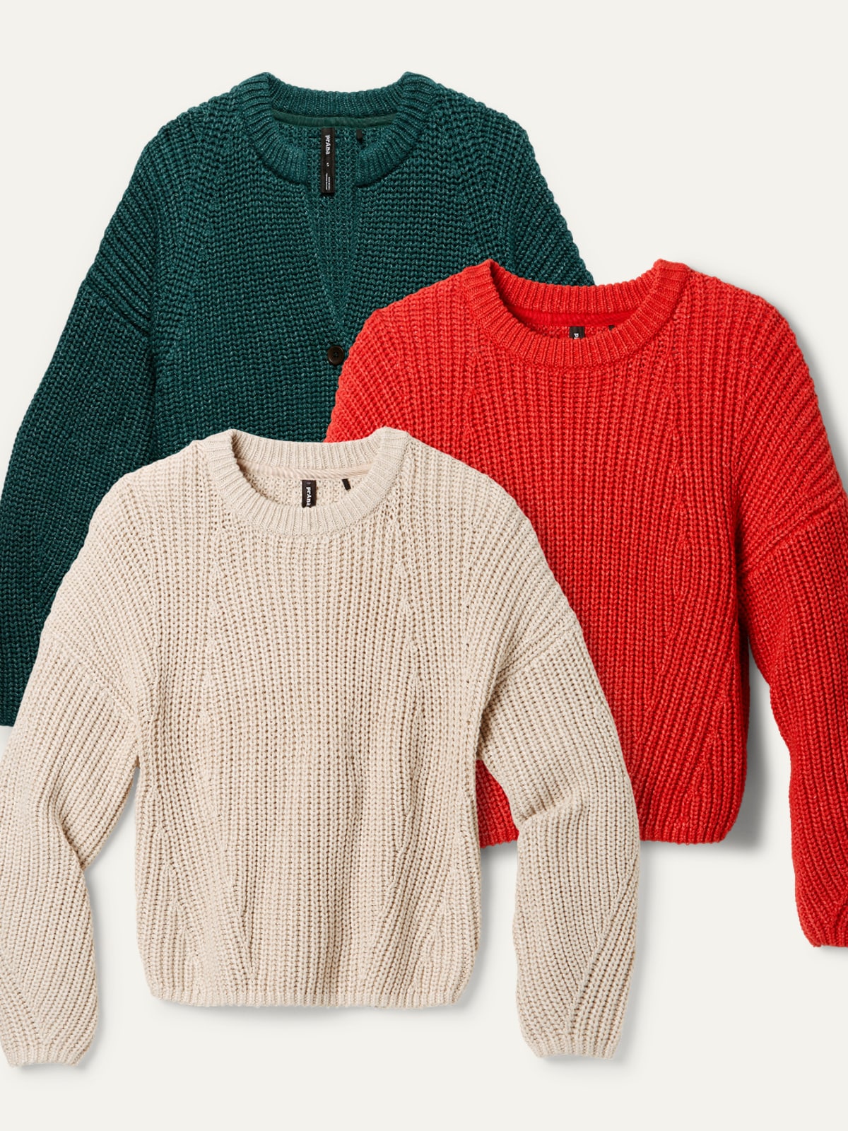 Three prAna sweaters on a light colored background.