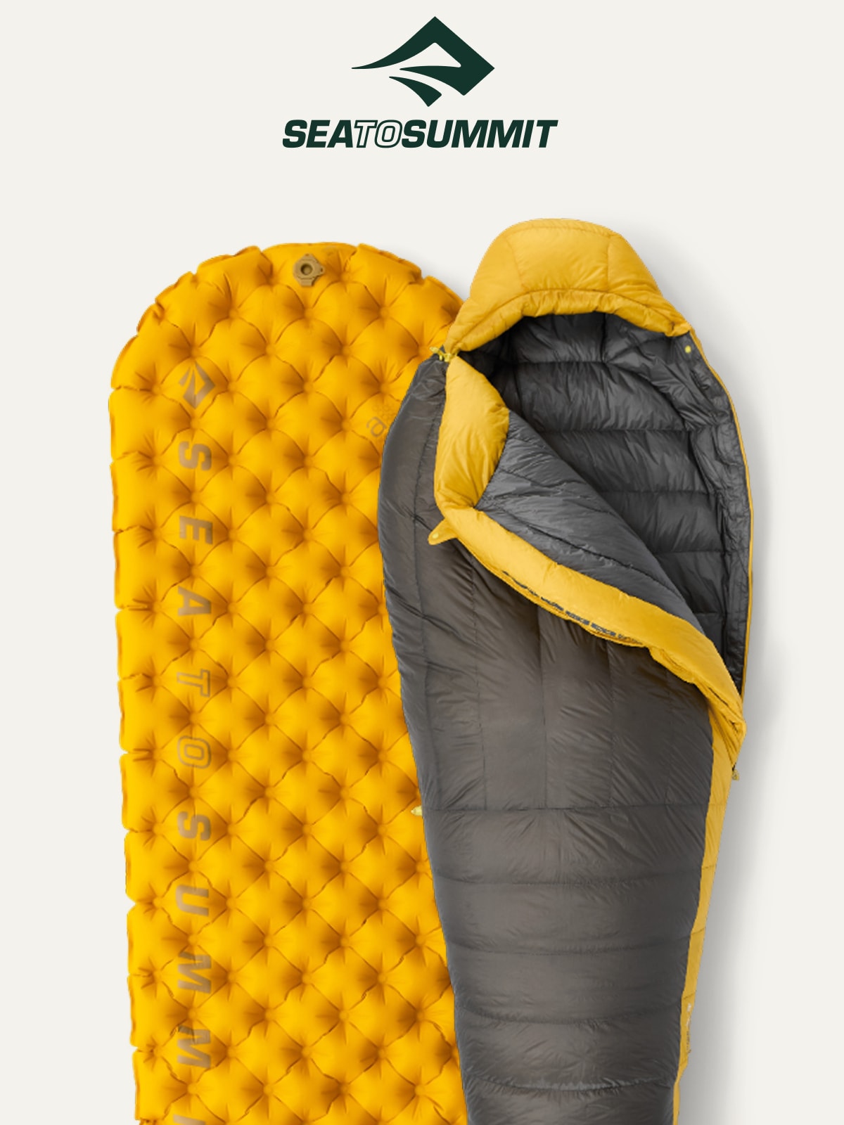 A Sea to Summit sleeping pad and bag on a light colored background.