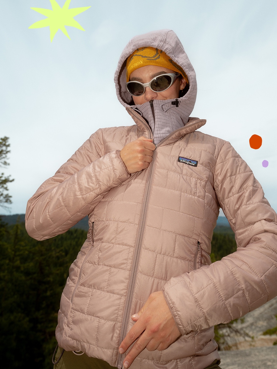 A person zips up their Patagonia jacket while looking at the camera.