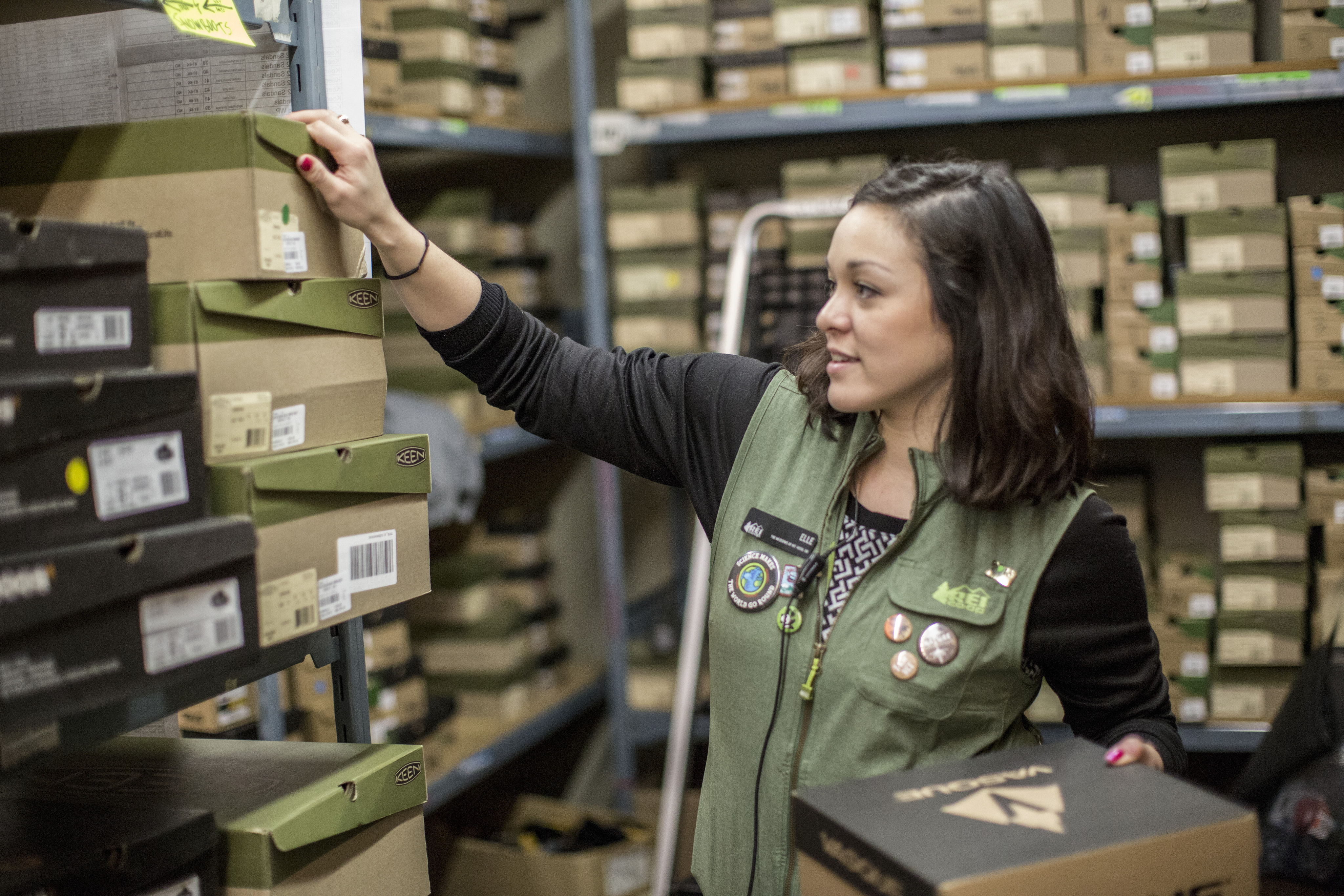 Worker pulls a shoebox off a storage shelf