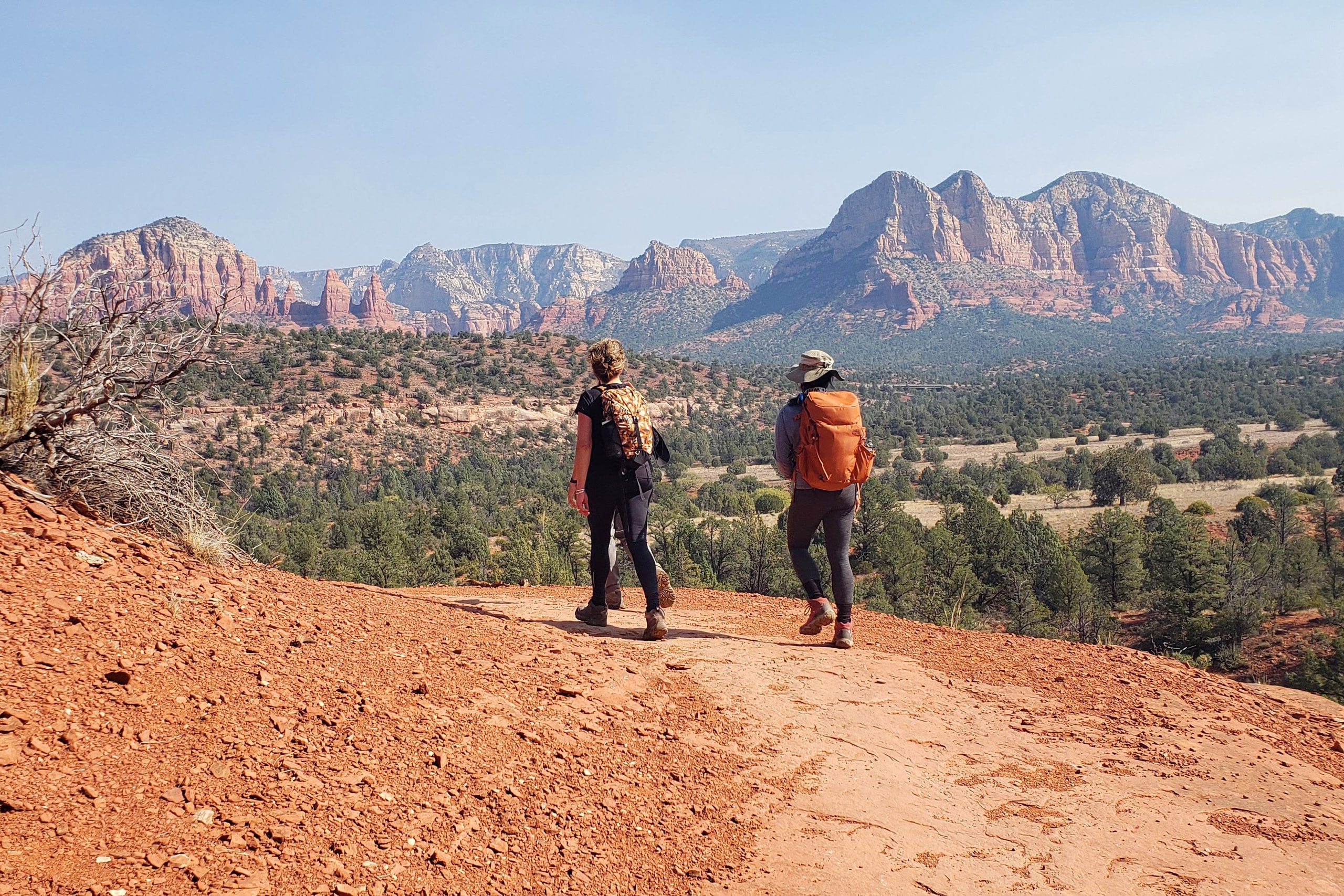 Two hikers in a mountainous desert landscape