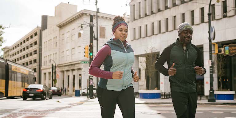 Two people jogging in an urban environment