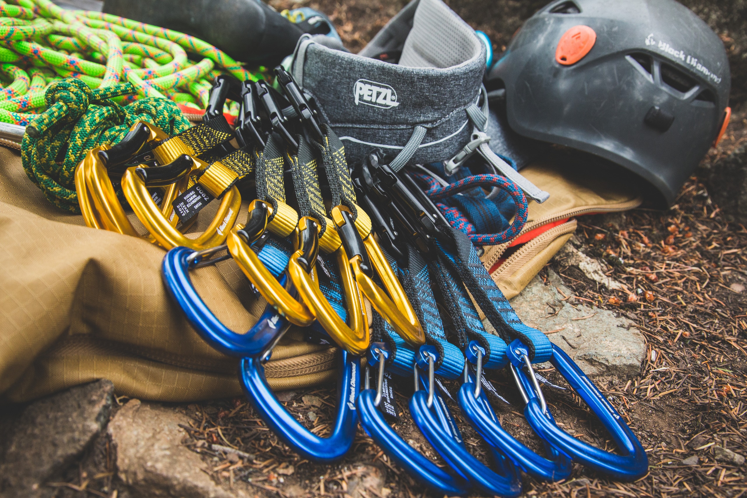 A photo of quickdraws that consist of orange and blue carabiners