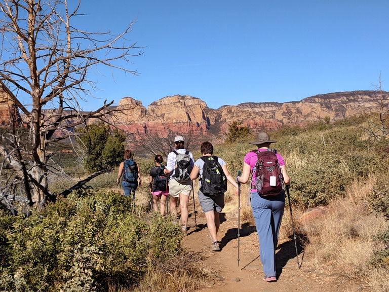 A group of five people hike in Sedona, Arizona