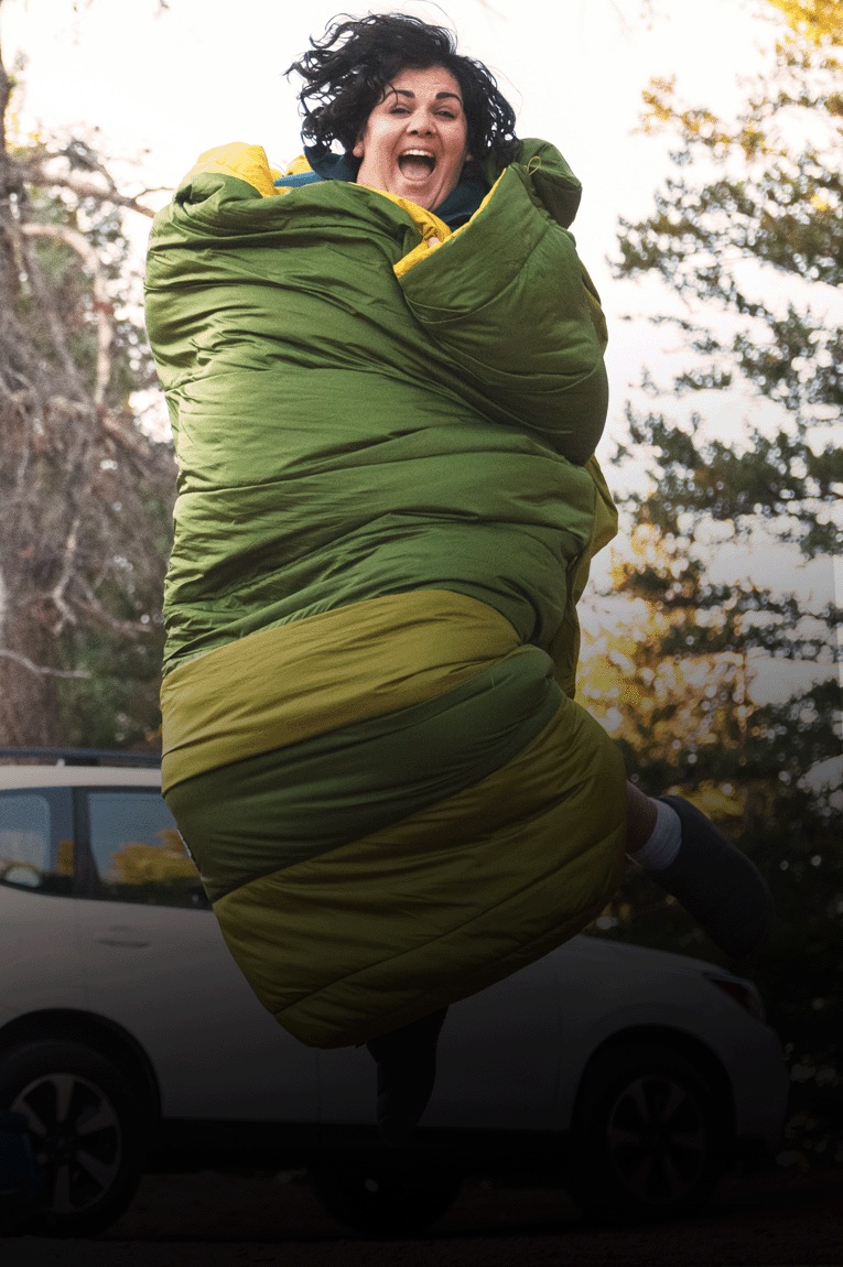 A camper sits in the Big Agnes Echo Park 20 sleeping bag