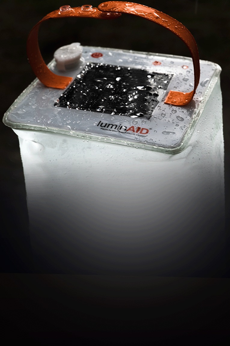 The LuminAID PackLite Max 2-in-1 Phone Charger with water droplets